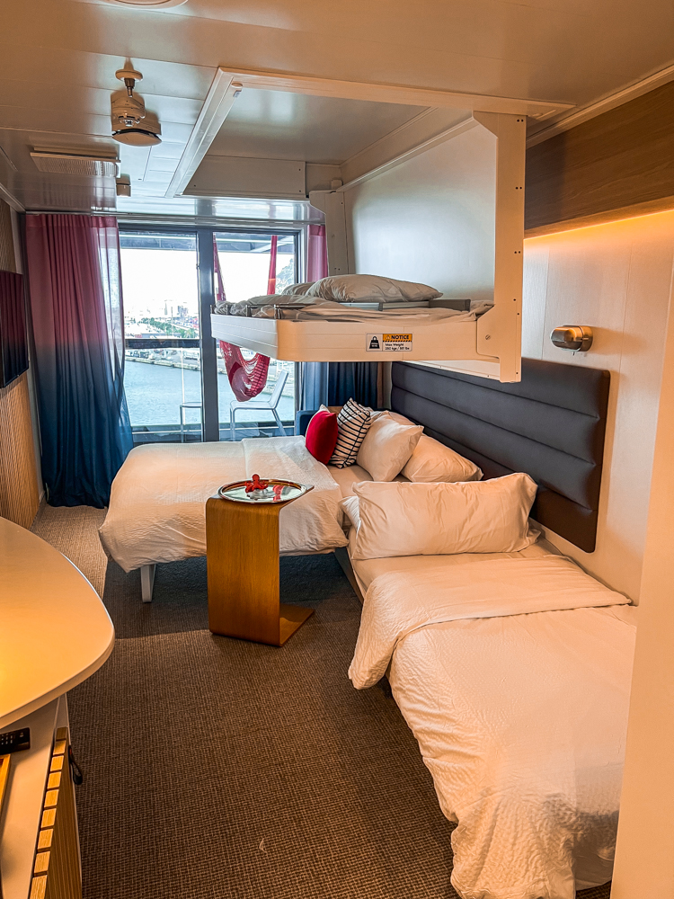 A cabin for four people on the Virgin Voyages Scarlet Lady Cruise.