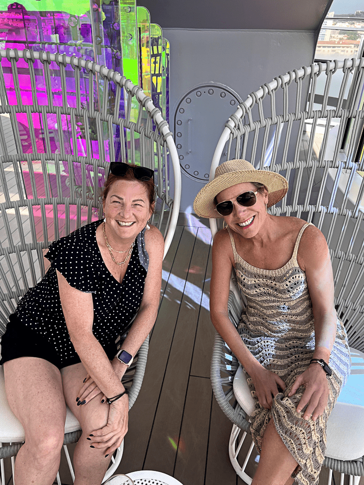 Jenny Lynn and a friend wearing casual, daytime clothes on a cruise.