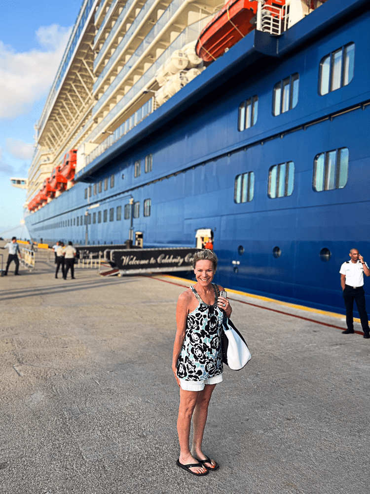 Jenny Lynn Anderson standing in front of a cruise boat, ready to board.