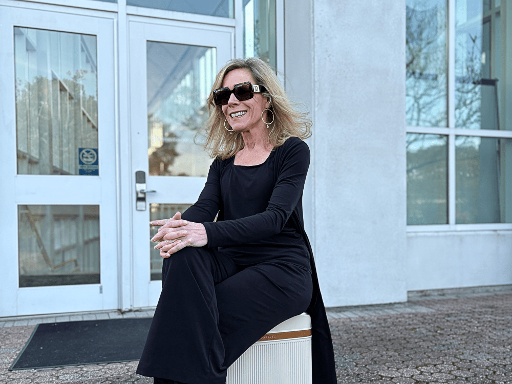 Jenny Lynn Anderson in a black dress and wearing sunglasses.