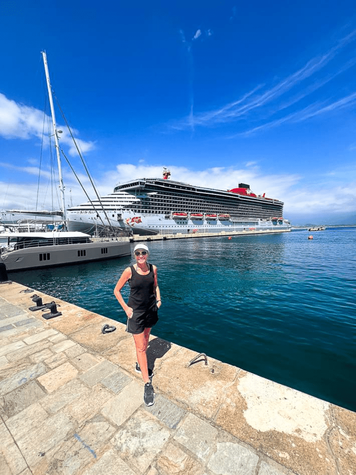 Jenny Lynn Anderson standing in front of a cruise ship.