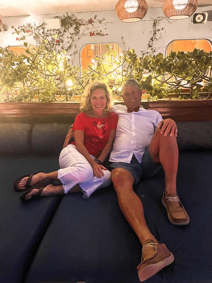 A couple sitting on a cruise.