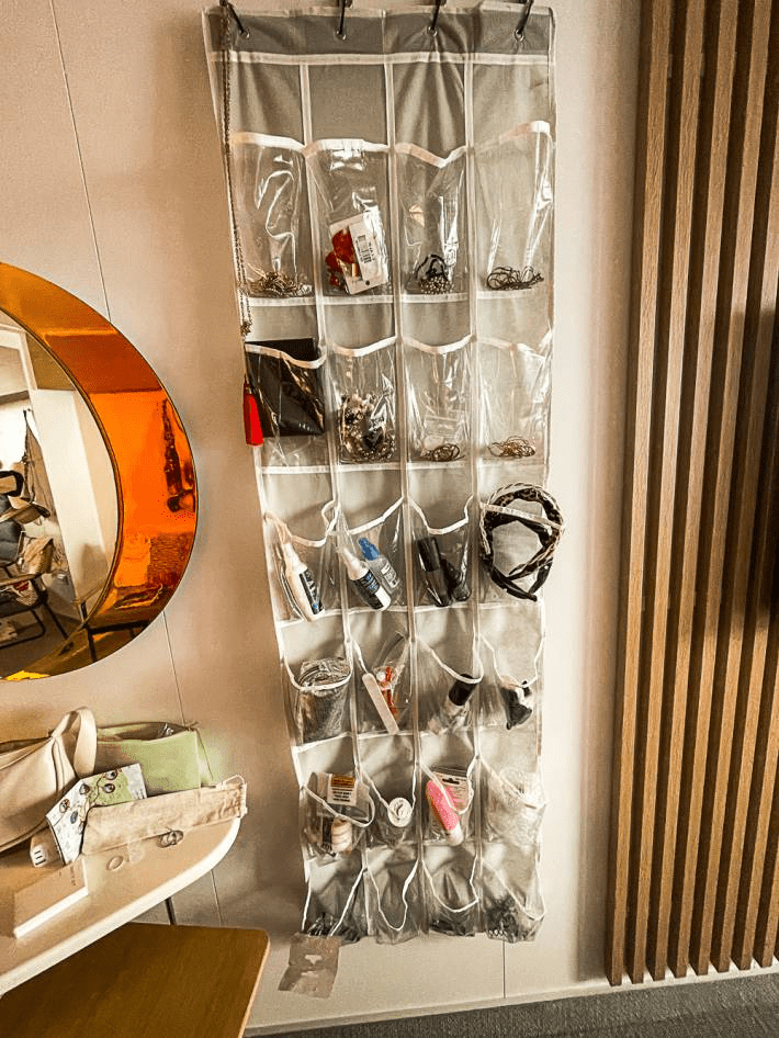 Travel accessories in an organizer on a wall.