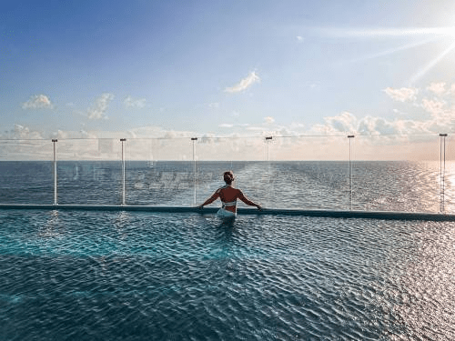 Jenny Lynn Anderson overlooking the ocean in the pool of a cruise ship.