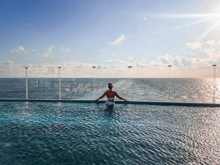Jenny Lynn Anderson overlooking the ocean in the pool of a cruise ship.