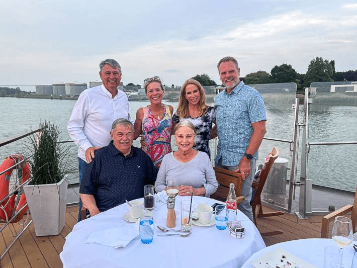 Jenny Lynn with a group of friends at a table on a cruise.