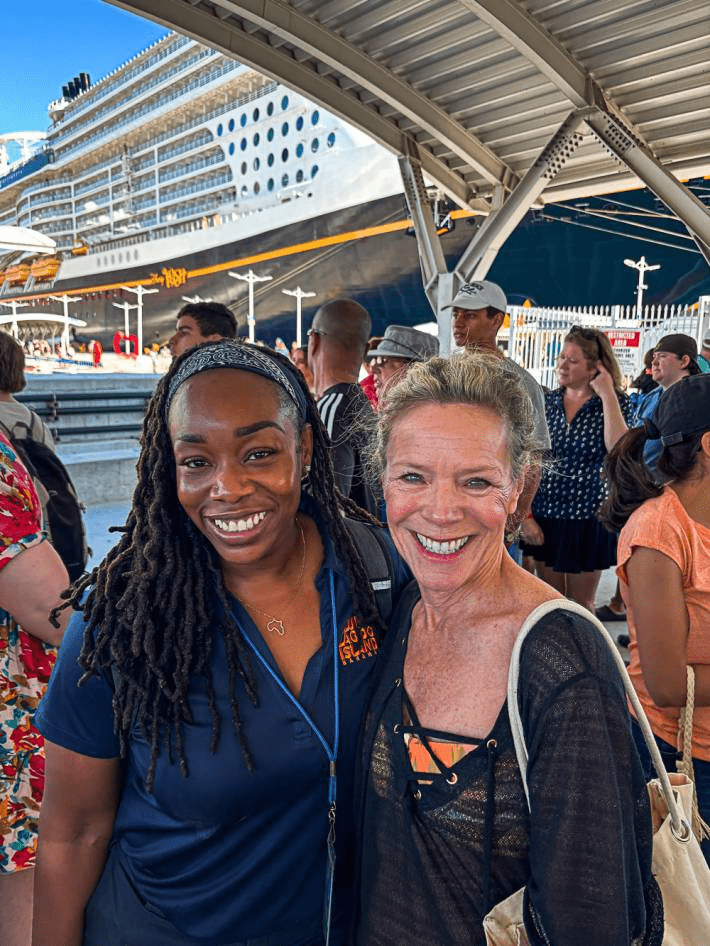 Jenny Lyn Anderson and a friend in front of the Carnival Cruise.