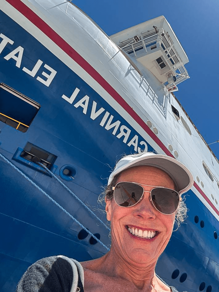 Jenny Lynn Anderson taking a selfie in front of the Carnival Cruise.