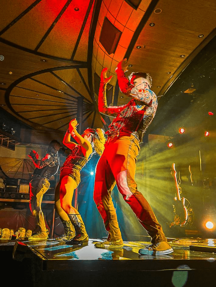 A show with people performing on the Carnival Cruise.