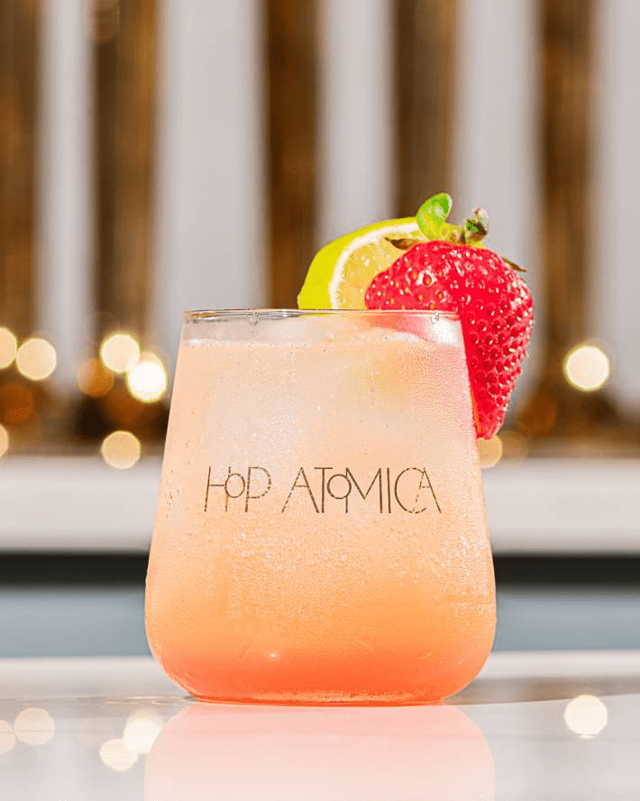 A Hop Atomica drink with a strawberry.