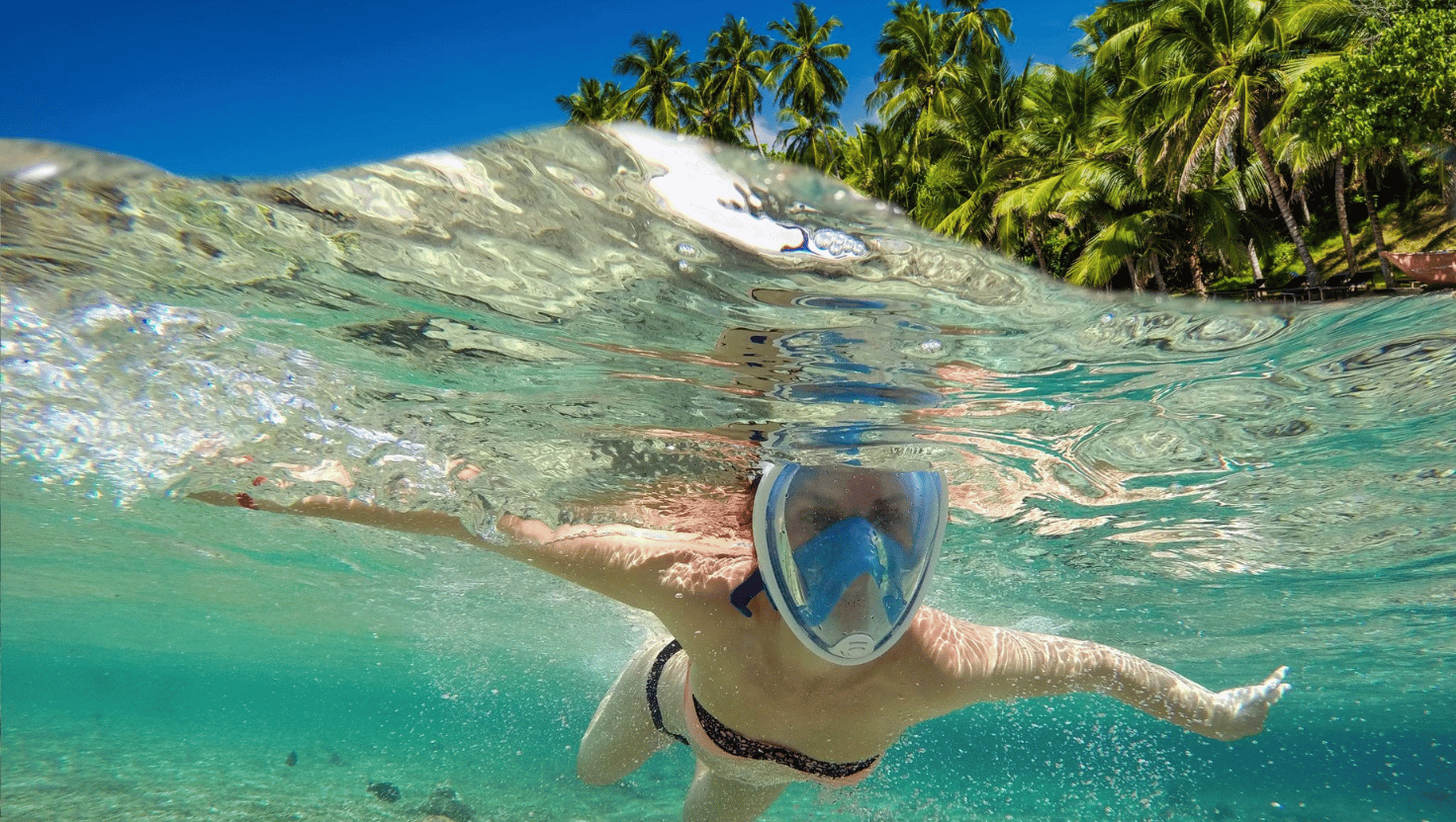 Person snorkeling on vacation. featured image for travel insurance blog post.