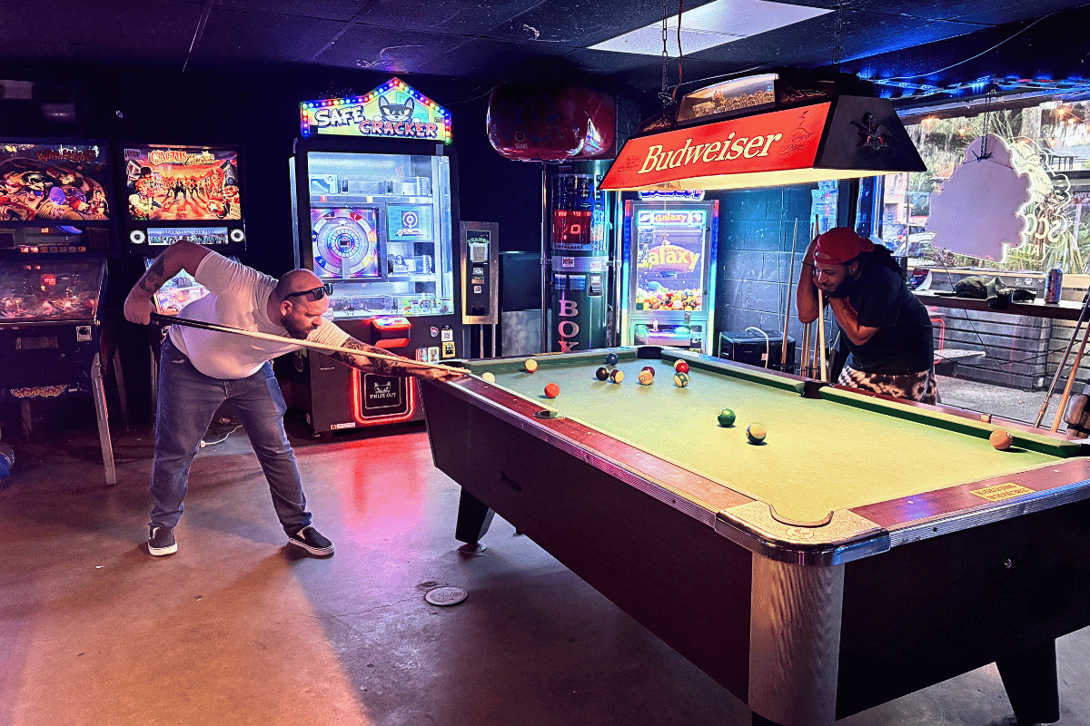 people playing pool at wormhole dive bar in savannah, ga.
